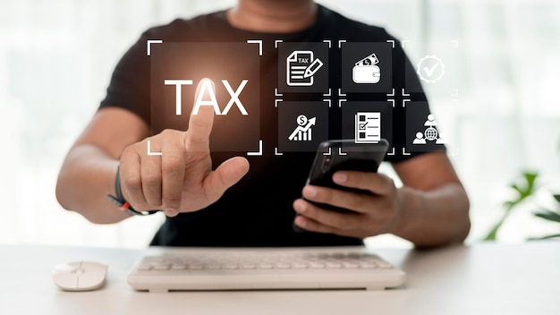 Financial researchgovernment taxes and calculation tax return concept Businessman using the laptop to fill in the income tax online return form for payment