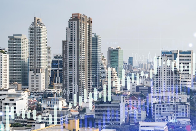 Financial stock chart hologram over panorama city view of Bangkok business center in Southeast Asia The concept of international transactions Double exposure