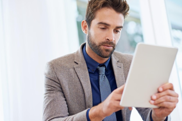 Finding a new way to keep track of meetings Shot of a businessman using his digital tablet