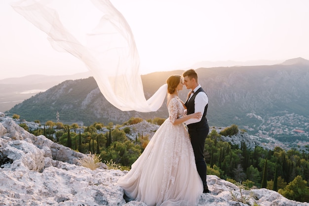 Fineart destination wedding photo in montenegro mount lovchen the wedding couple hugs on top of the