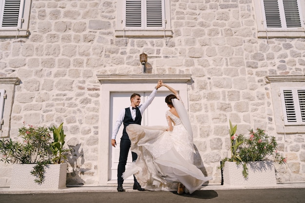 Fineart wedding photo in montenegro perast the bride and groom are dancing against the backdrop of