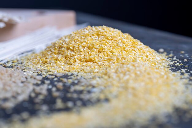 Finely crushed corn kernels into flakes for making porridge