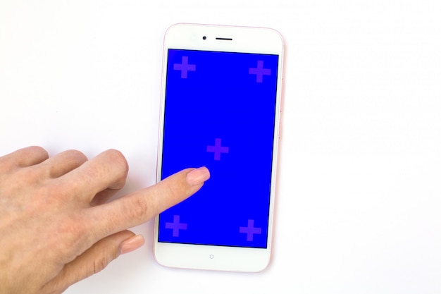 Finger presses on mobile phone display with blue screen