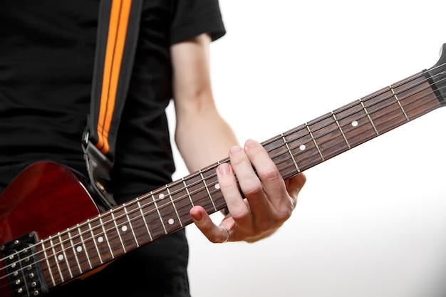 Fingers on the electric guitar fretboard.