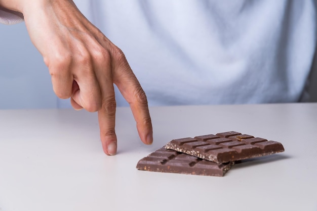 Fingers walking towards a chocolate sweetxA