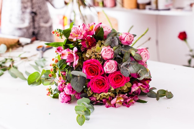 Finished bouquets on the table in the flower shop. Creating the floristic decorations