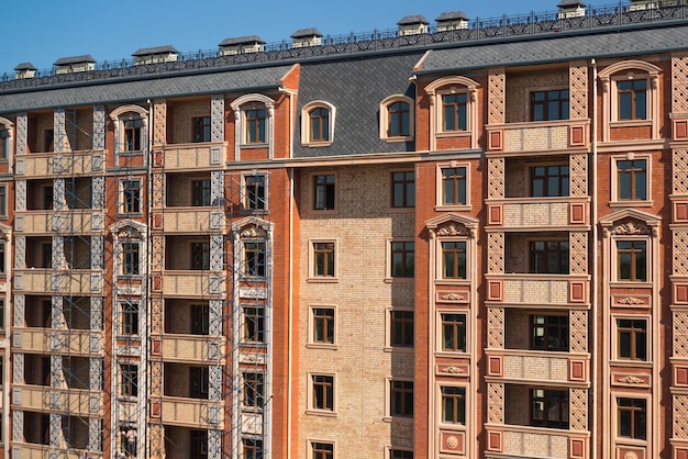 Finishing works on the facade of a new residential buildings