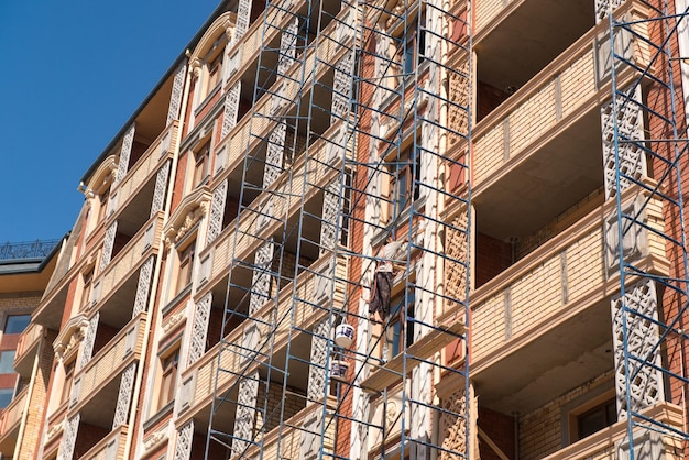 Finishing works on the facade of a new residential buildings