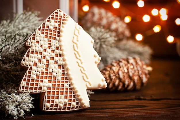 fir branches Christmas balls and decorations garland on a wooden background