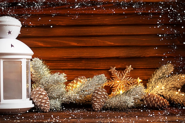 fir branches Christmas balls and decorations garland on a wooden background