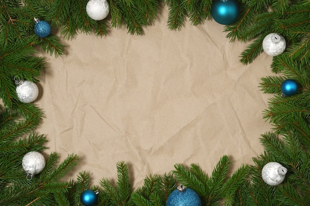 Fir branches with christmas ornament on paper background