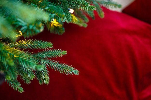 Fir branches with garland background of blurred pillow