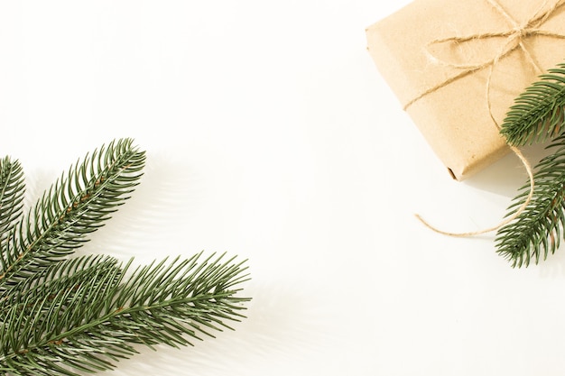 fir branches with pine cones and gifts in craft paper