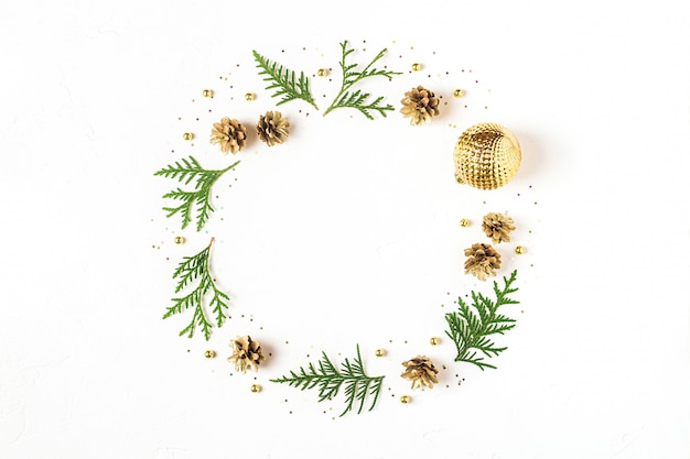 Fir leaves and pine cones with ornaments