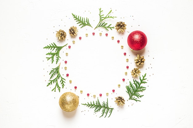 Fir leaves and pine cones with ornaments