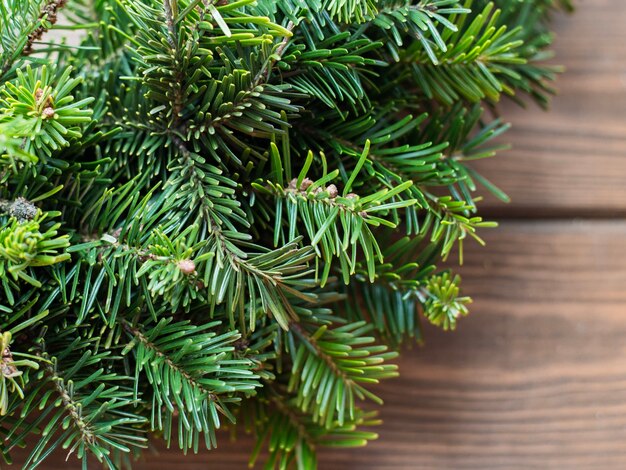 Fir-Tree branch on rustic wooden background used for christmas decoration