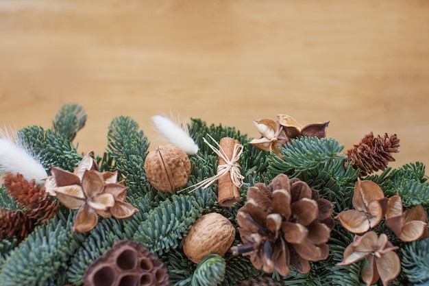 Photo fir tree branches with christmas decorations on wooden , copyspace, flat lay.  new year's, holiday, christmas decoration.