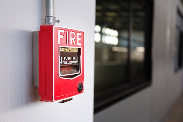 Fire alarm switch on the wall in factory.