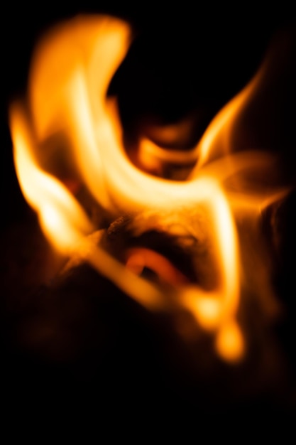 Fire closeup and red orange yellow color detail texture and abstract shape on black background