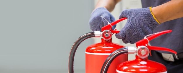 Fire engineering checking pressure gauge level of fire extinguisher