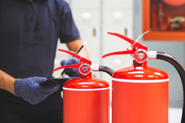 Fire extinguisher engineer checking pressure gauges