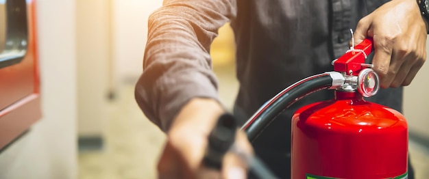 Fire extinguisher has hand engineer checking to prepare fire equipment