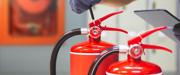 Fire extinguisher has hand engineer checking pressure gauges