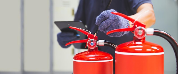 Fire extinguisher has hand engineer checking pressure gauges