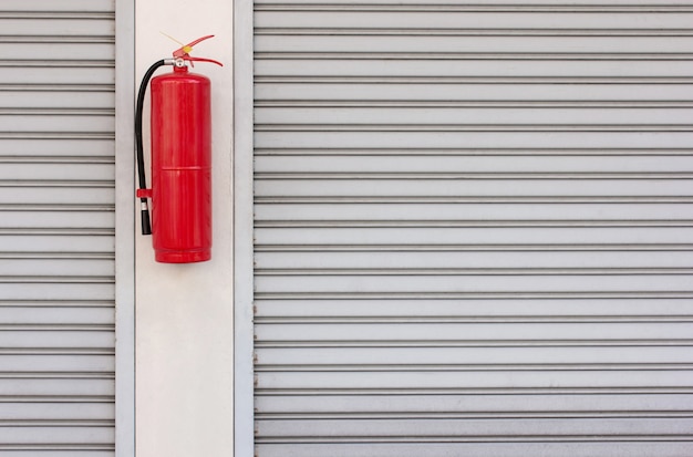 Fire extinguisher on the shutter door at home