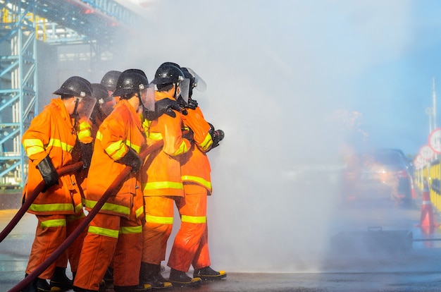 Fire fighters spray water for fire drills in industrial plants.