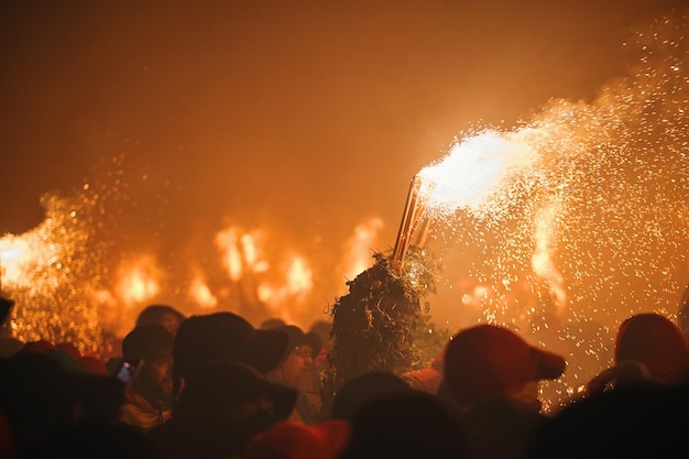 Fire party with crowds of people during the corpus