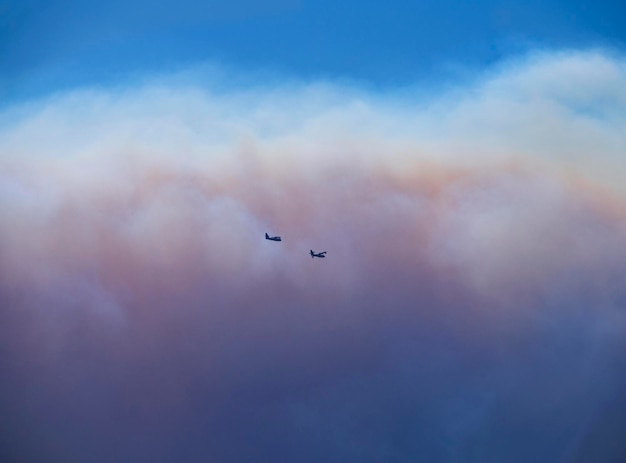 Fire planes on the background of smoke from fire and fire on the Greek island of Evia Greece