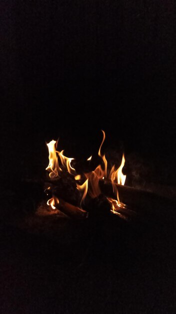 a fire that is outside with a black background