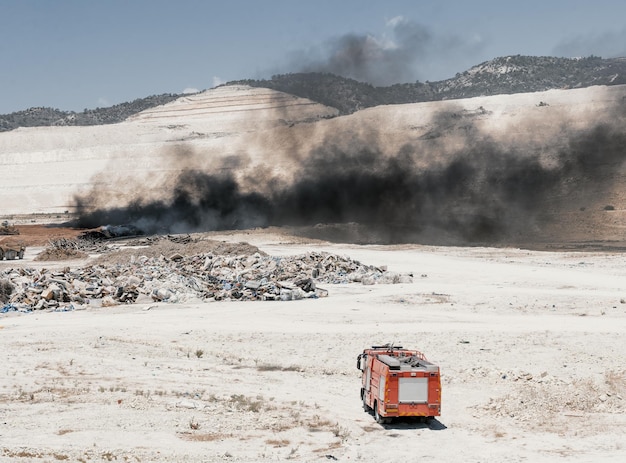 Fire in a tire dump heavy black smoke from burning old tiresxA