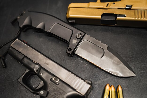 Photo firearms and steel arms folding tactical knife and pistols high quality photo