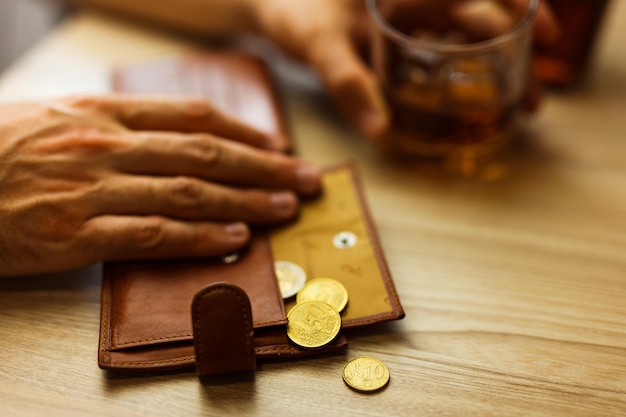 Fired man countsing his last money to drink expensive alcohol