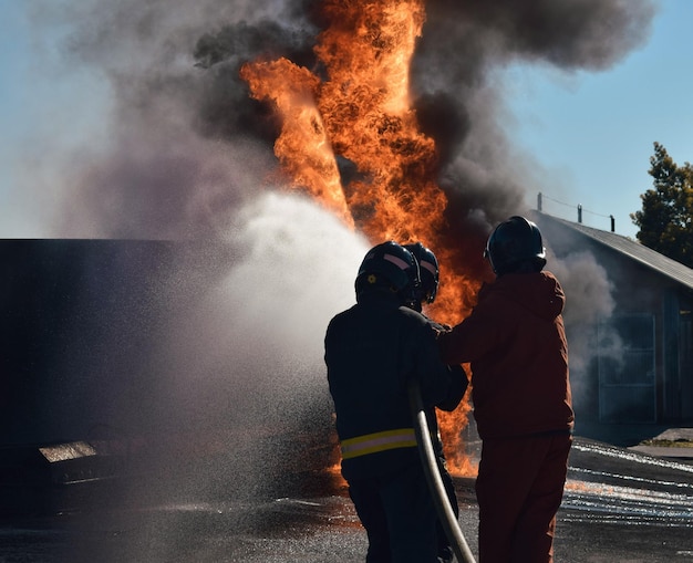 Firefighter extinguishing a traffic accident fire