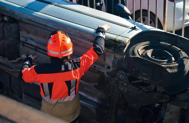 Firefighter in front of a crashed car