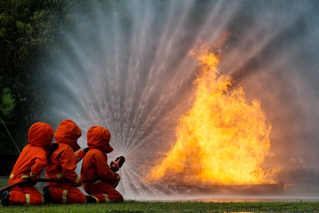 Firefighter spray water to fire burning car workshop fire training