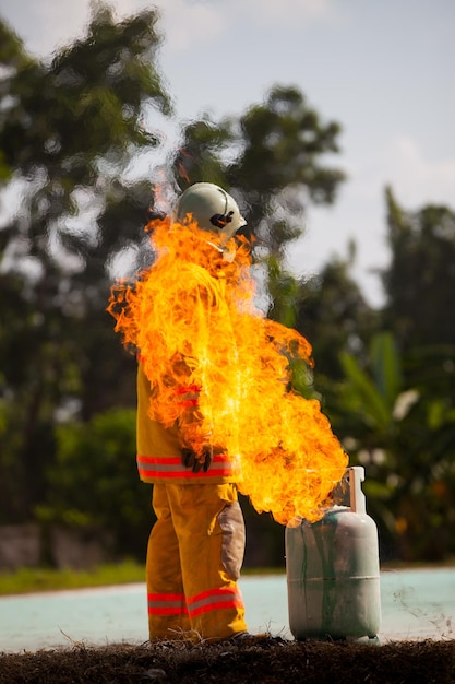 Firefighter with fire and suit for protect fire fighter for training firefighters