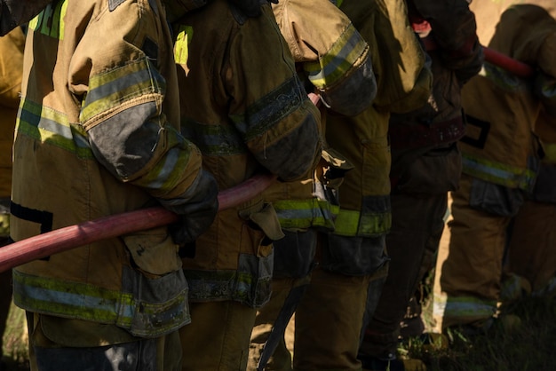 Firefighters and rescue training Firefighter spraying high pressure water to fire Burning fire flame background