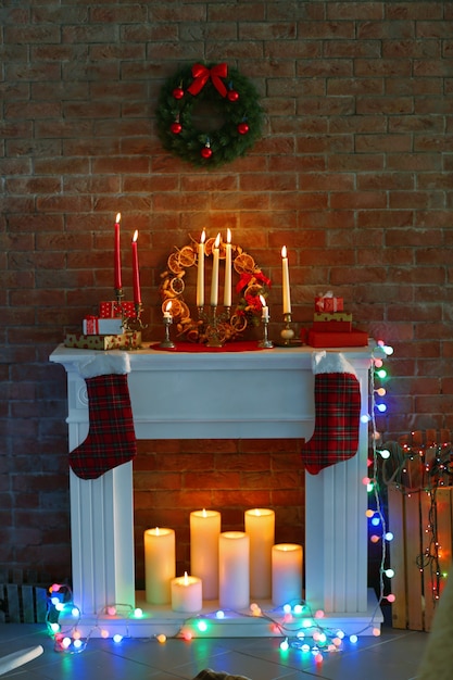 Fireplace with beautiful Christmas decorations in comfortable living room