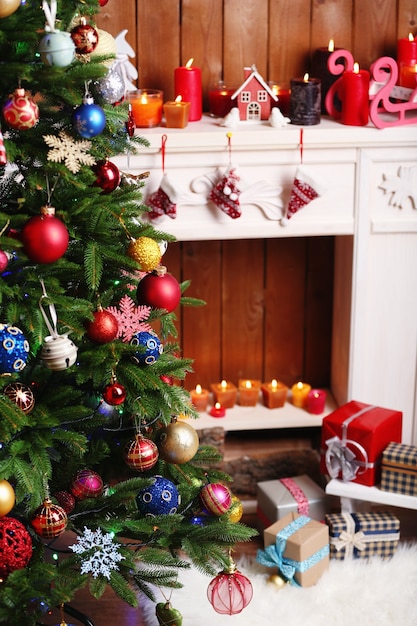 Fireplace with beautiful Christmas decorations in room