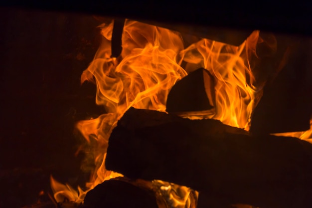 The firewood is burning with an orange fire in the fireplace Heating of the house without electricity