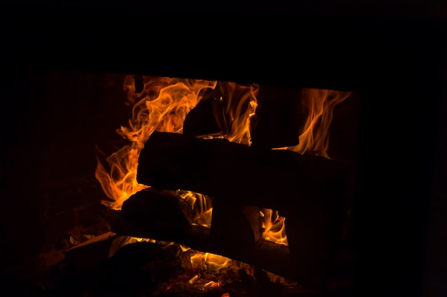 The firewood is burning with an orange fire in the fireplace Heating of the house without electricity