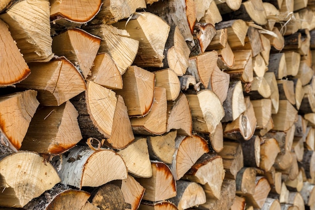 Firewood stacked in the woodpile textured firewood background of chopped wood