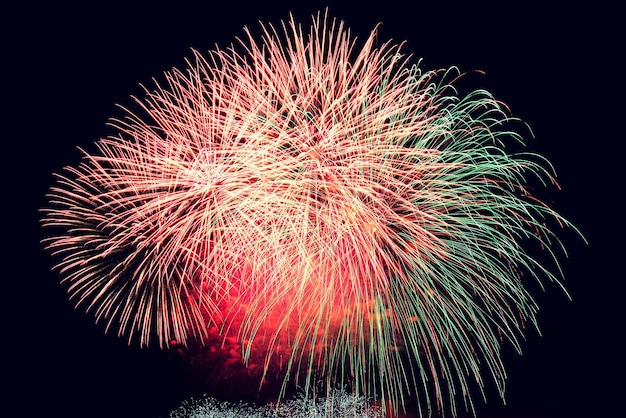 Firework Beautiful colorful fireworks on the water surface with a clean black background Fun festival and contest of Firefighters Brno Dam Czech Republic