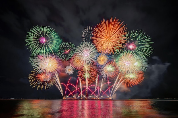 Firework display by sea at night