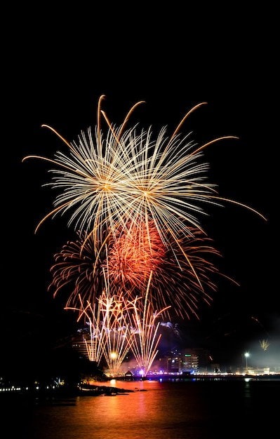 Firework display over river at night