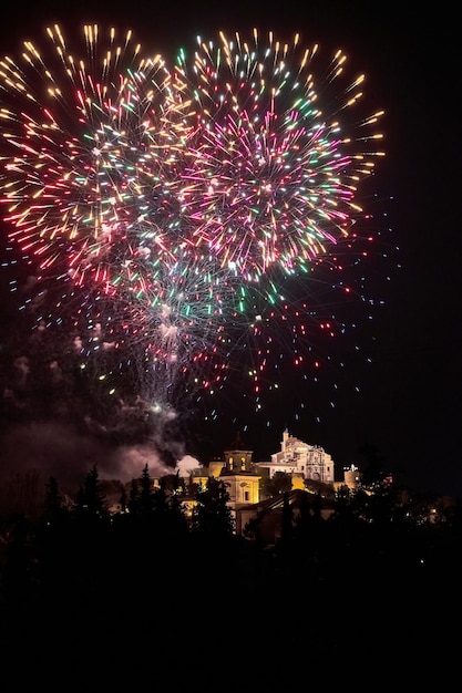 Fireworks over a castle in the night sky